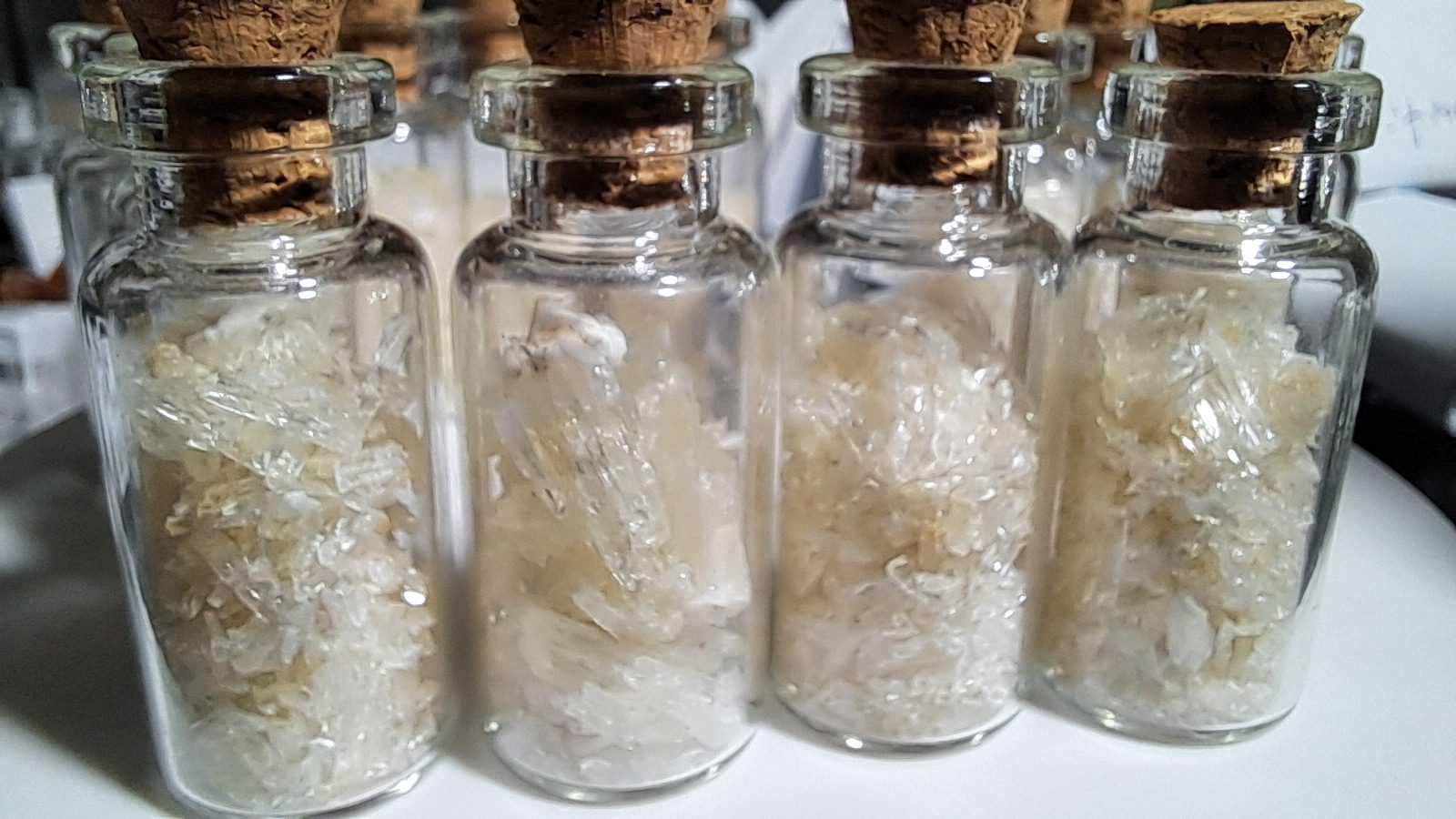 Phosphorescent Cave Calcite Shards in a glass Cork Bottle